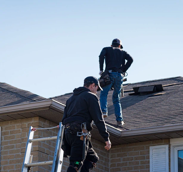 workers inspecting roof